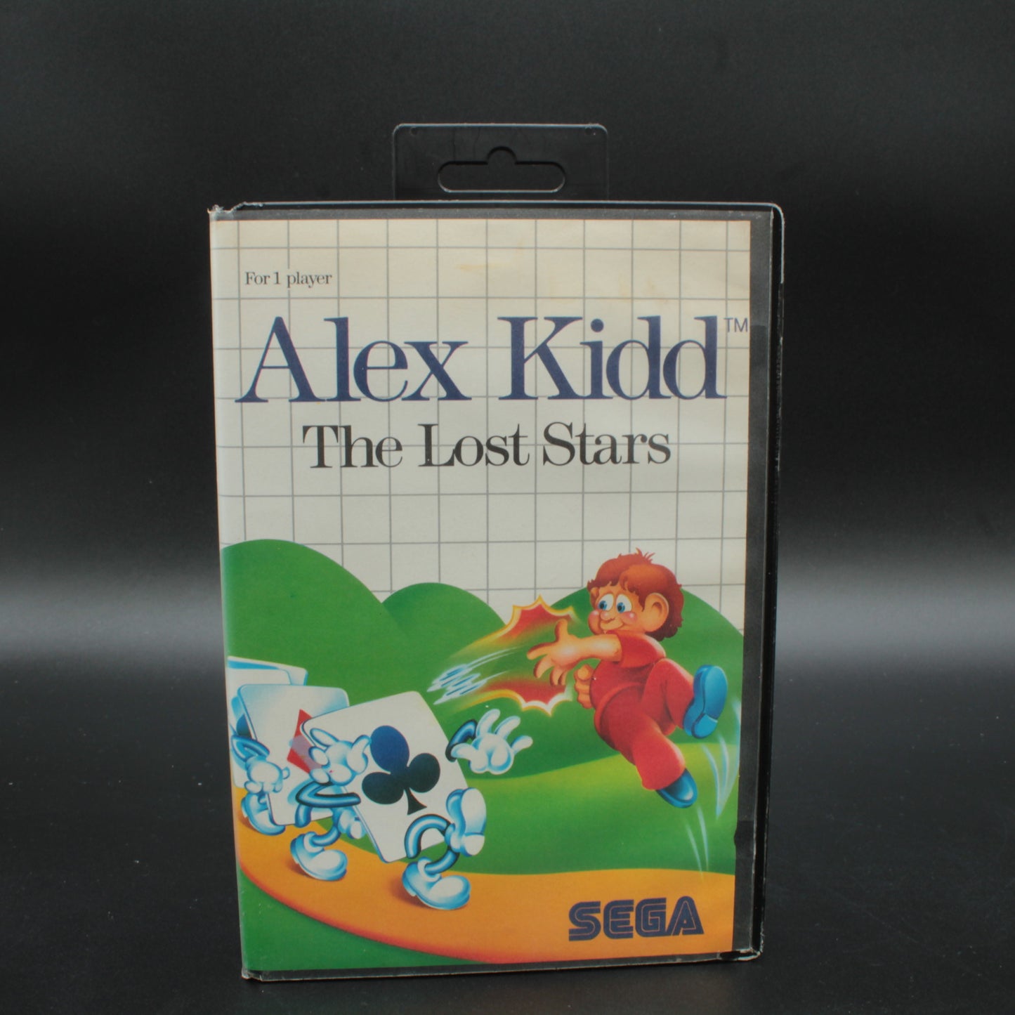 Vintage 'Alex Kidd: The Lost Stars' SEGA game cartridge packaging on a dark background RARE RETRO