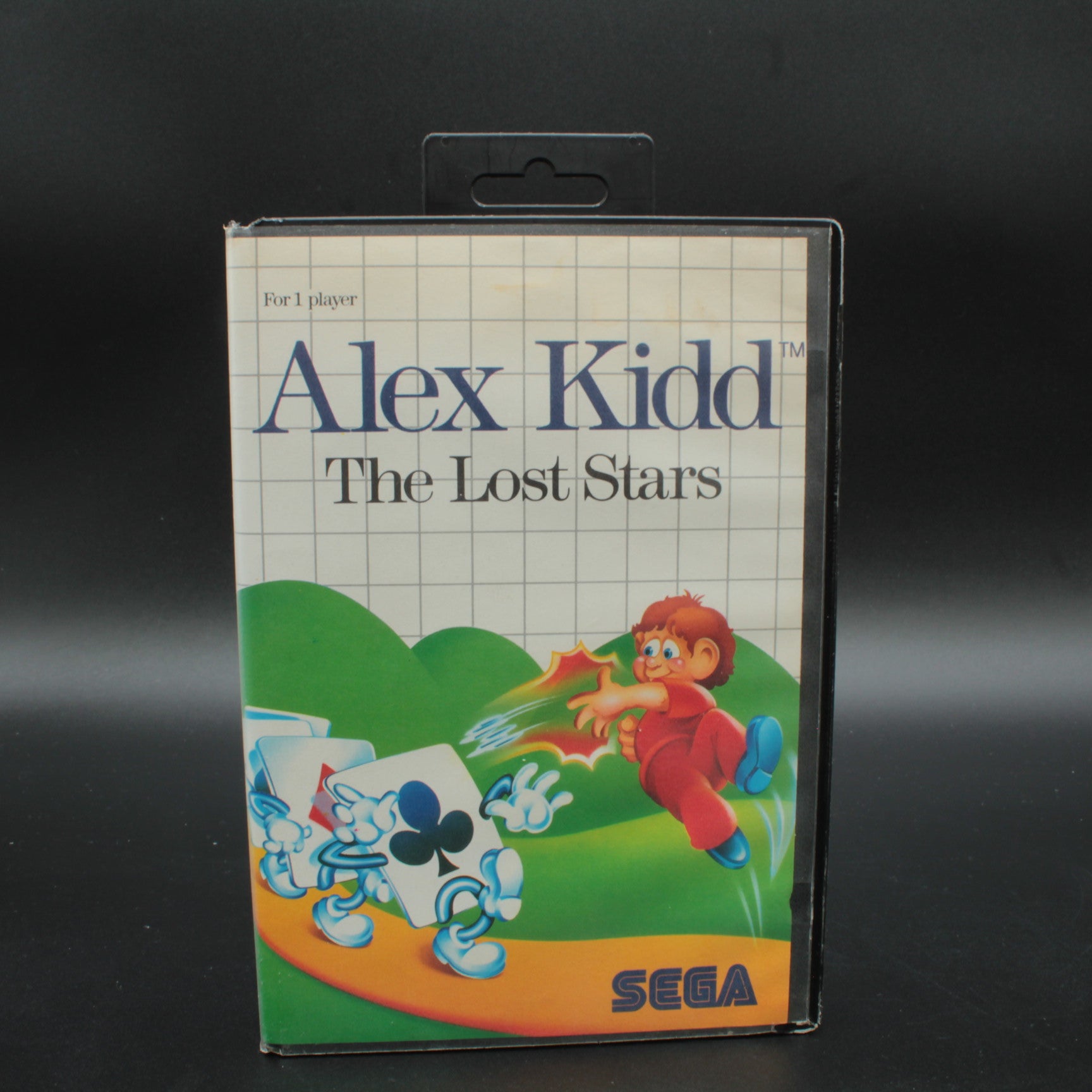 Vintage 'Alex Kidd: The Lost Stars' SEGA game cartridge packaging on a dark background RARE RETRO