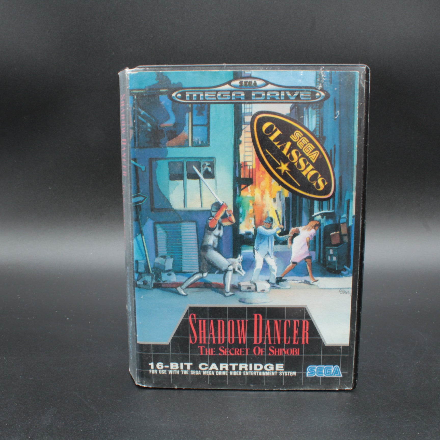 Sega Mega Drive game cartridge for 'Shadow Dancer: The Secret of Shinobi' on a dark background