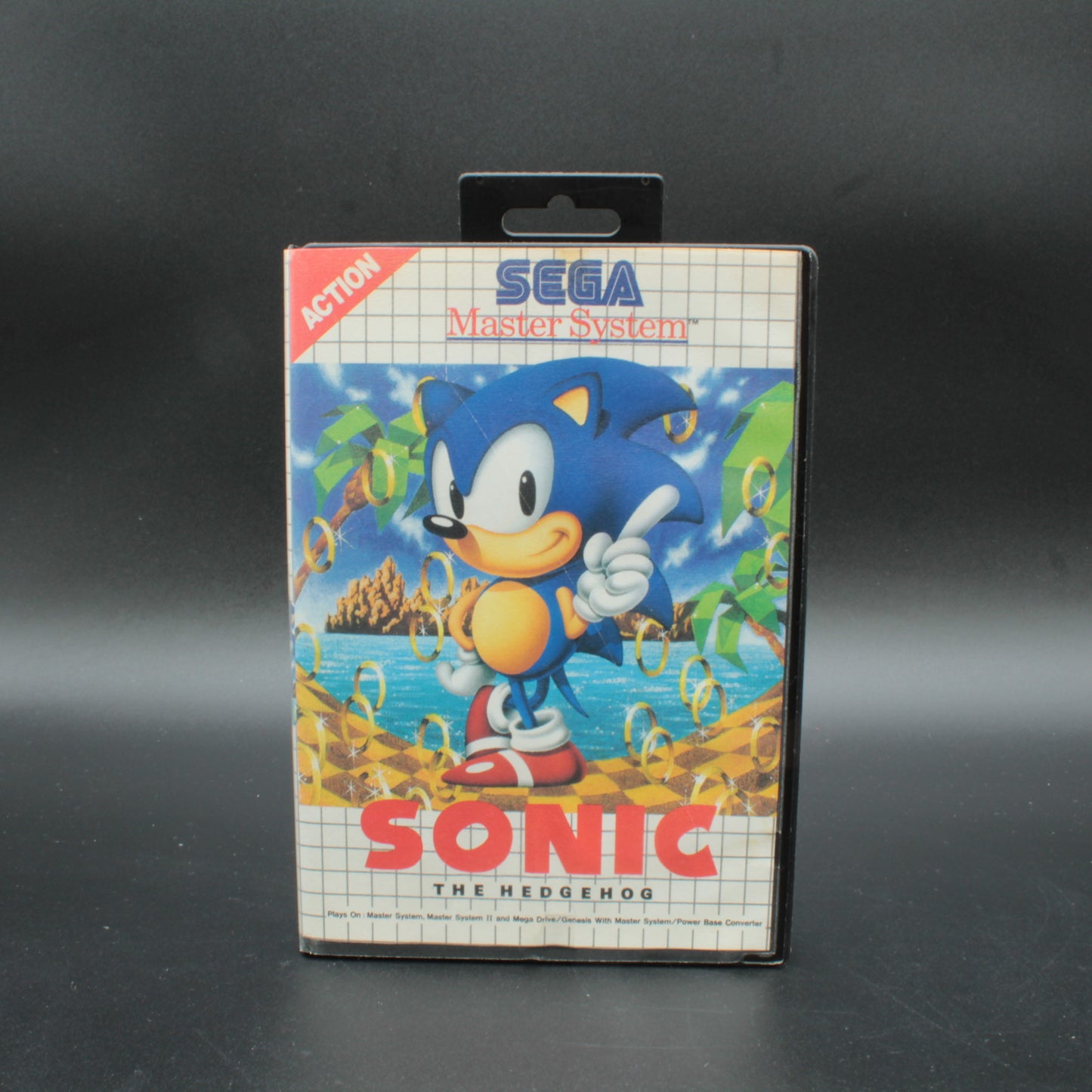 Sega Master System Sonic the Hedgehog game cartridge on a black background