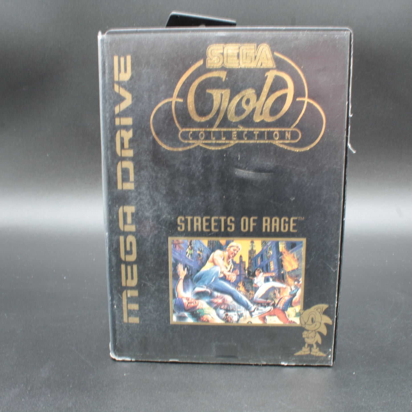 Sega Mega Drive game cartridge for 'Streets of Rage' in the Sega Gold Collection on a gray background